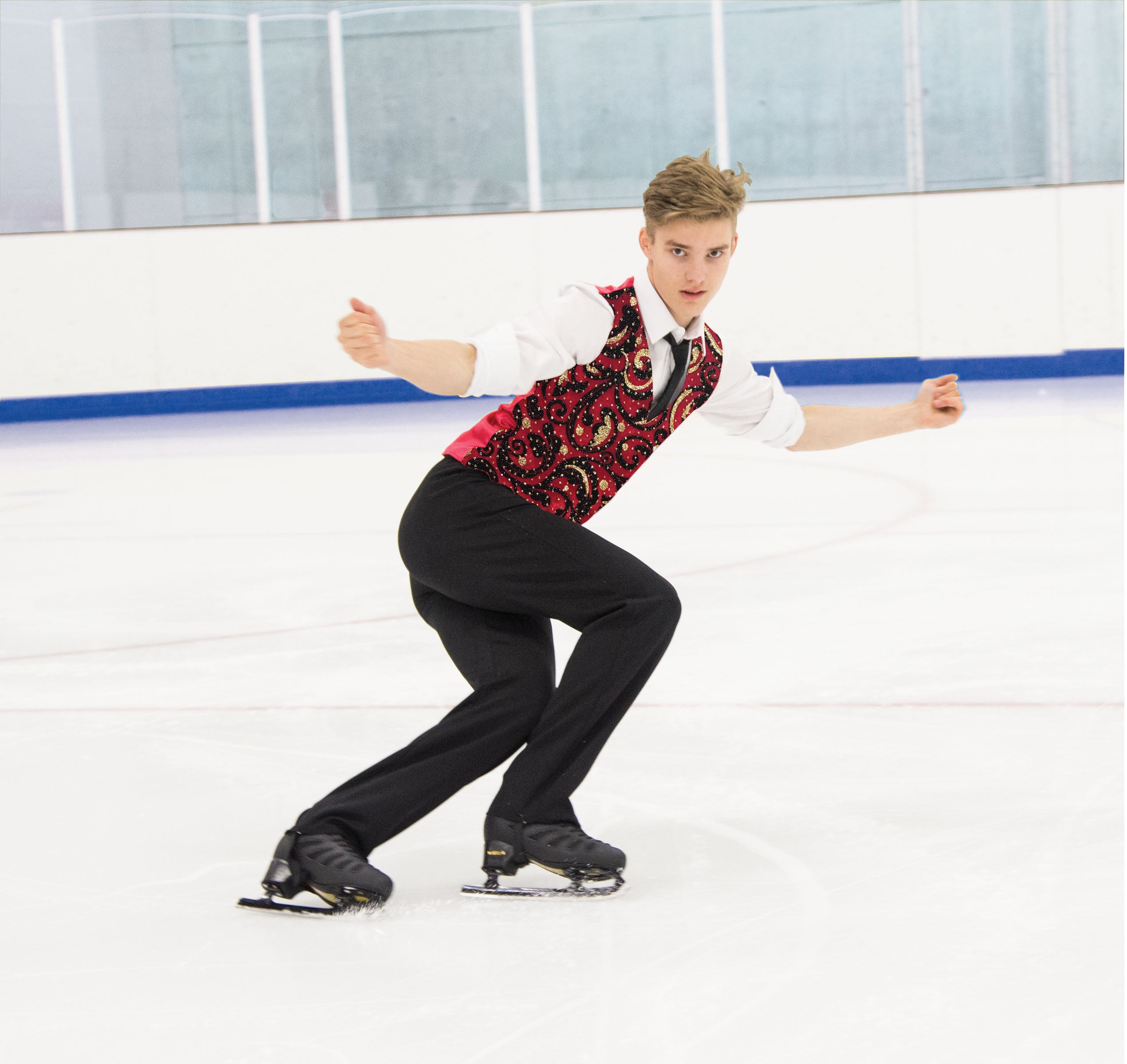 Tailored JR832 Men's Red Carpet Vest in red and black velvet, worn during a figure skating routine on ice rink.