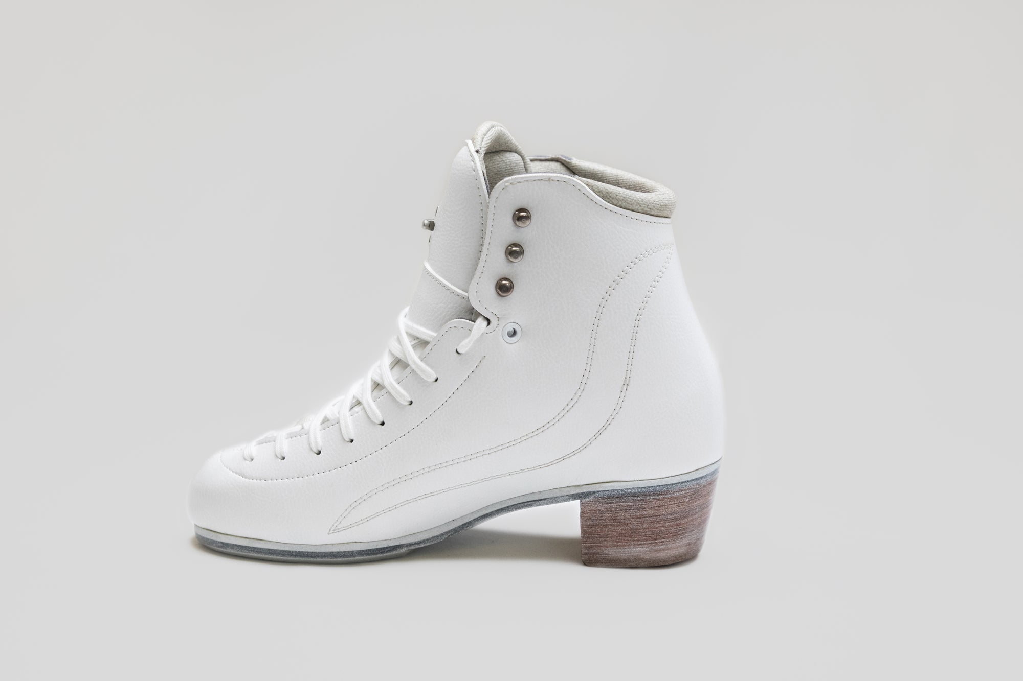 Left side view of Riedell Vega womens figure skate boot with triple eyelet design and stitched detailing for style and function.