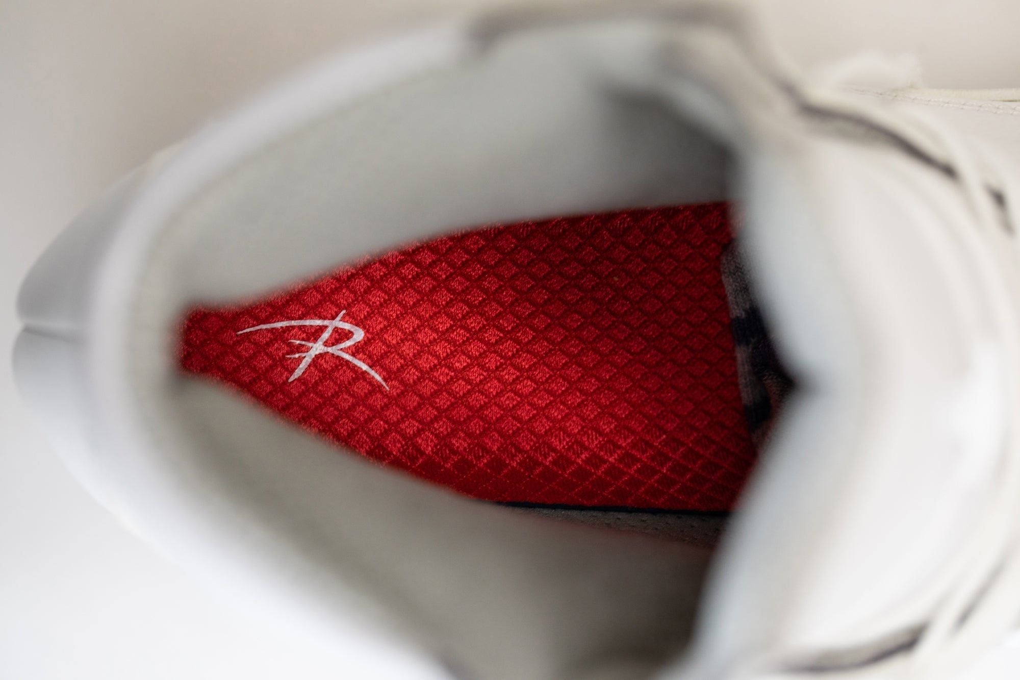 Inside view of Riedell Elara womens figure skate boots featuring red cushioned insole with Riedell logo for added foot support.