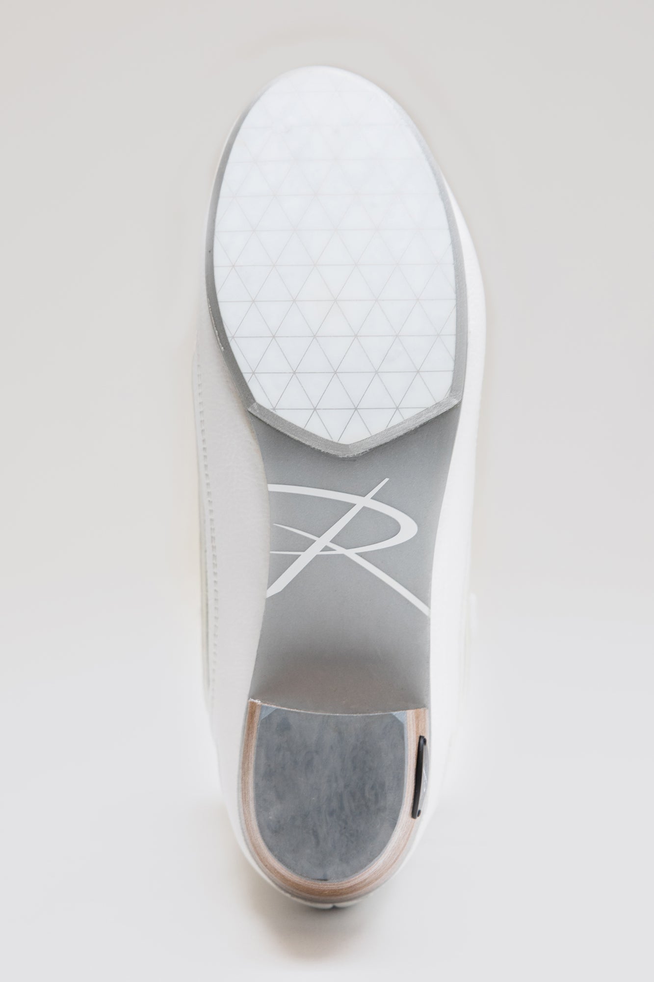 Bottom sole of Riedell Elara womens figure skate boots with geometric grip pattern and Riedell branding for traction and style.