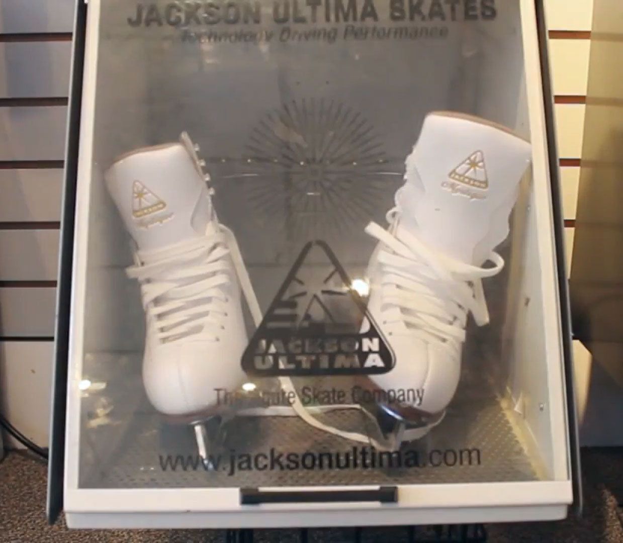 Display of Jackson Ultima figure skates in a professional fitting booth, showcasing custom skate fitting for optimal performance.