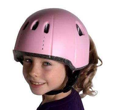 Wuevo Ice Skating Helmet in pink worn by a child, showcasing front ventilation and secure fit for figure skating safety and style.