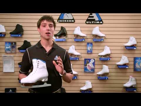 Retail expert showcasing Jackson Finesse 150 womens ice skates in a store with figure skating gear, highlighting comfort and design features.