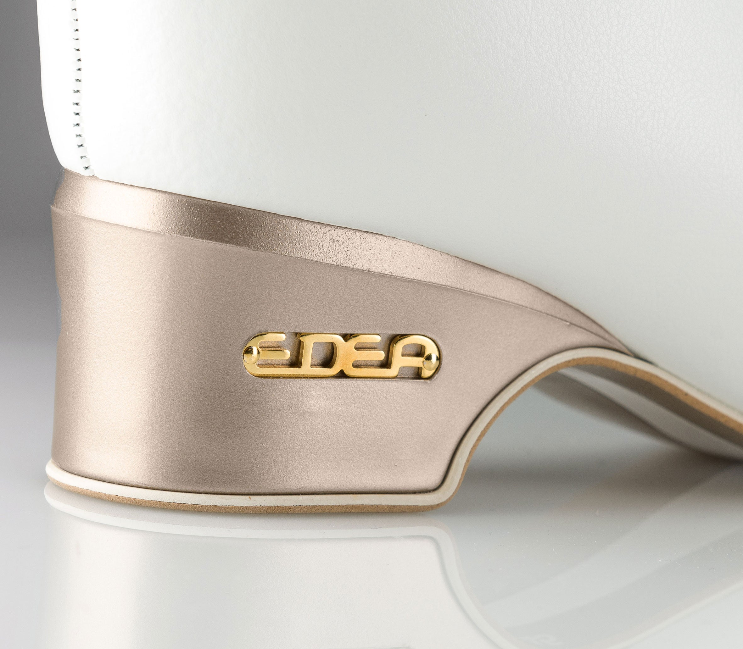 Detailed heel view of Edea Concerto Figure Skate Boot in white with gold Edea logo, highlighting elegant and durable heel construction.