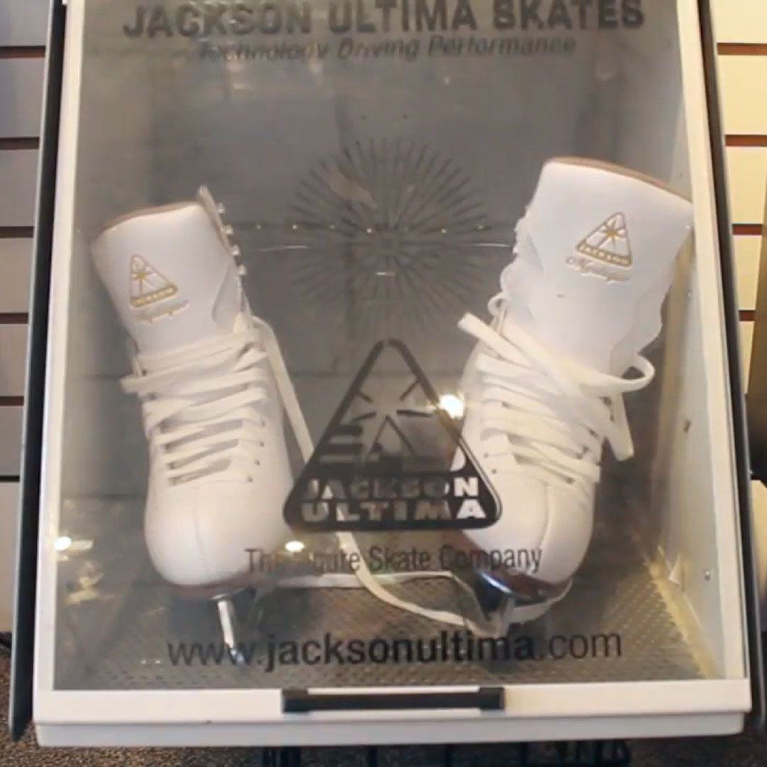 Display of Jackson Ultima figure skates in a professional fitting booth, showcasing custom skate fitting for optimal performance.